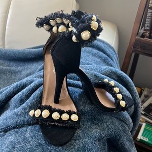 Never worn outside. Only at a fitting. Still has the band around the ankle strap